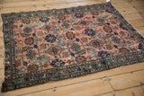 Detail of antique Mehriban rug's dusty rose field, sapphire palmettes, Herati motif, even wear.