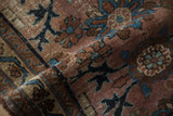 Visible wear on hand-knotted pile texture with dusty plum and sapphire blue hues.