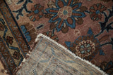 Antique Mehriban rug's worn pile, revealing woven foundation and tattered fringe.