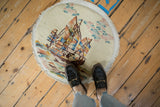Pictorial ocean motif with ivory fringe on the vintage Art Deco round rug.