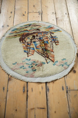 Detail of vintage Art Deco round rug: ivory pile, curved edge, colorful pictorial ocean.