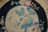 Early 20th century Art Deco rug with dusty blue foliage and dusty rose florals on navy.