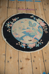 Art Deco rug detail: pictorial hut, trees, dusty rose flowers, and sky blue mountains.