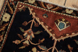 Hand-knotted detail of a madder red border and navy tree-of-life field on a Farahan Sarouk.