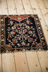 Angled view of a square antique Farahan Sarouk rug showing its full Tree of Life design.