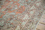 Distressed terracotta and dusty blue vine motifs on a vintage Turkish Sparta carpet.