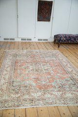 Distressed Turkish Sparta carpet border: terracotta, dusty blue, beige, oxidized silver vine motifs.