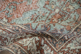 Distressed vintage Sparta carpet close-up, showing textured terracotta, beige, and dusty blue pile.