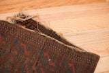 Frayed edge detail of the hand-knotted Balouch tribal rug, showcasing its wool foundation and mallard green.