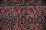 Detailed pile of antique Persian Lilihan rug: time-softened magenta field, teal bird motifs.