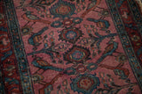 Antique Lilihan runner detail: dusty magenta field with teal bird and palmette motifs.