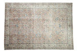 Distressed hand-knotted Oushak carpet with allover dusty mauve, beige, sapphire blue floral palmettes.