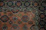 Antique Bibikabad rug corner, copper field, navy border, floral designs. Expert restoration visible on minor border.