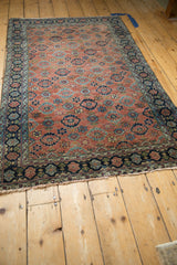 Antique Bibikabad rug detail: Copper field with Veramin floral motifs, blue abrashes, and navy border.
