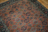 Antique Bibikabad rug's copper field with Veramin inspired floral blossoms, and dark navy floral border.