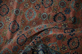 Close-up of antique Bibikabad rug's copper field, Veramin-inspired blue floral design, and patterned border.