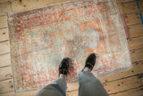 Kaisary rug's lustered rust, silver, and pale gold pictorial field with animal border.
