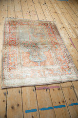 Angled view of the vintage Kaisary rug, showcasing its faded pictorial design and lustrous pile.