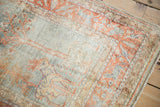 Vintage Kaisary rug corner showcasing terracotta and oxidized silver animal border.