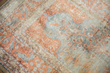 Vintage Kaisary rug's soft mercerized pile with terracotta border and stylized tree-of-life pattern.