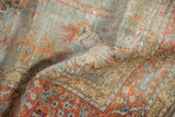 Lustrous mercerized pile with pictorial design in silver, rust, and pale gold on a Kaisary rug.
