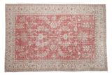 Distressed vintage Oushak carpet with pale raspberry floral field and ivory arabesque border, 7'1