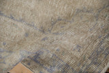 Faded ivory and pale blue distressed Oushak rug texture, with mostly even wear.