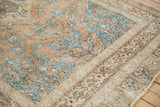 Distressed vintage Sparta rug detail with ochre, turquoise, and ivory geometric floral patterns.