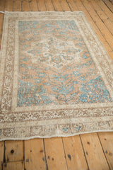Worn pile on Turkish distressed Sparta rug with ochre and turquoise geometric blossoms.