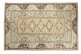 Vintage Distressed Melas carpet, gold ochre medallions, floral accents, beige and dark brown borders.