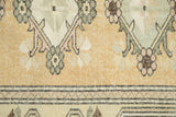 Distressed Melas carpet texture highlighting banded borders and floral details in ochre, green, and pink.