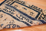Genuine aged, tattered blue border with stylized motifs on an early Peking rug.