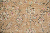 Close-up showing the worn knot heads and sprawling floral vinery of a distressed Sparta rug.