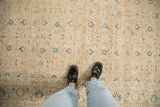 Distressed Sparta rug's faded dusty sandalwood and navy floral texture underfoot.