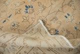 Distressed vintage Sparta carpet pile featuring faded floral vinery, navy accents, and bound edge.