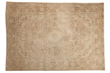 Distressed vintage Turkish Tabriz rug, faded beige tones, geometric floral medallion.
