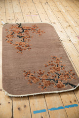 Antique Art Deco rug detail: embossed terracotta cherry blossoms, corkscrewed branches.