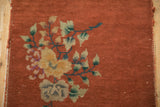 Antique Chinese Art Deco rug detail: copper field, dusty teal vines, ivory, gold blossoms.