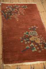 Tattered edge and woven side of the copper Art Deco runner with dusty teal floral vines.