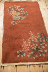 Copper field of antique Art Deco runner, with textured pile, dusty teal vines, and tattered edge.