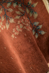 Copper-toned pile texture of an antique Chinese Art Deco runner, displaying knot heads.
