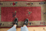 Antique Chinese Art Deco runner: raspberry red field with cloudband and vase border motifs.