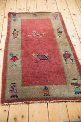 Antique Chinese Art Deco rug border detail: raspberry red field, oxidized silver, Taoist vase motifs.