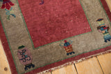 Chinese Art Deco runner detail: raspberry field, oxidized silver border, mauve vase motif, aged fringe.