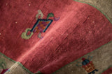 Antique Chinese Art Deco rug: textured raspberry red field, cloudband, and border motifs.