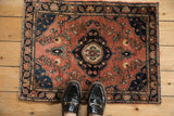 Left edge of antique Farahan Sarouk, showing dusty brick red field with delicate floral vinery.