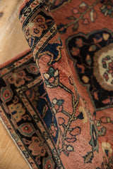 Antique Farahan Sarouk rug: hand-knotted pile with intricate floral vinery in dusty brick red, dark navy, and teal.