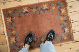 Antique Art Deco rug border with scrolling vines, mint green leaves, and gold blossoms.