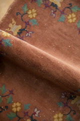 Dusty copper pile of antique Chinese Art Deco rug showing floral vines and white knots.