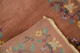 Antique Art Deco rug's dusty copper pile with white knots and intricate woven foundation.